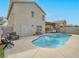 Backyard featuring private pool, covered patio, desert landscaping and cozy outdoor seating area at 5364 Awbury Ave, Las Vegas, NV 89110