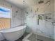 Luxurious bathroom showcases free standing tub and separate glass enclosed shower with tile surround and built-in niche at 5364 Awbury Ave, Las Vegas, NV 89110