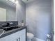 Modern half bathroom with black marble countertop and stylish fixtures at 5364 Awbury Ave, Las Vegas, NV 89110