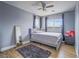 This secondary bedroom features a ceiling fan, plush carpeting, and large windows with window coverings at 5364 Awbury Ave, Las Vegas, NV 89110