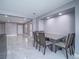 Dining area with a modern table, sleek tile flooring, and natural light, perfect for Gathering gatherings at 5364 Awbury Ave, Las Vegas, NV 89110