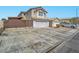 Inviting two-story home showcasing a wide driveway, two car garage, and decorative gate for added privacy at 5364 Awbury Ave, Las Vegas, NV 89110