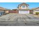 Inviting two-story home showcasing a wide driveway and a secure, decorative gate for added privacy at 5364 Awbury Ave, Las Vegas, NV 89110