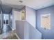 Upstairs hallway featuring wood-look floors, neutral paint, and natural light at 5364 Awbury Ave, Las Vegas, NV 89110