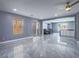 Bright living room with tiled floor, open layout, and a view into the dining area at 5364 Awbury Ave, Las Vegas, NV 89110
