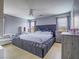 Large main bedroom with a plush bed, light hardwood floors, and neutral decor at 5364 Awbury Ave, Las Vegas, NV 89110