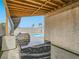 Outdoor kitchen with granite counters, stainless steel grill and view of backyard pool and palm trees at 5364 Awbury Ave, Las Vegas, NV 89110