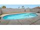 Backyard view of the refreshing private swimming pool with surrounding concrete decking and privacy wall at 5364 Awbury Ave, Las Vegas, NV 89110