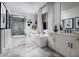 Bright bathroom featuring a modern tub, separate shower, marble floors, and double vanity at 5715 Golden Chase Ct, Las Vegas, NV 89131
