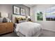 Stylishly decorated bedroom with neutral tones, featuring plush bedding, side tables and bright windows at 5715 Golden Chase Ct, Las Vegas, NV 89131