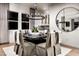 Elegant dining room featuring modern chandelier, hardwood floors, and a view into the kitchen at 5715 Golden Chase Ct, Las Vegas, NV 89131