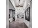 Bright foyer with high ceilings, wood floors, statement lighting, with seamless access to other living spaces at 5715 Golden Chase Ct, Las Vegas, NV 89131