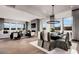 Open concept living space with fireplace, large windows, hardwood floors, and dining area at 5715 Golden Chase Ct, Las Vegas, NV 89131