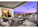 Spacious outdoor patio includes a built-in kitchen, dining area, comfortable seating and landscaped yard at 5715 Golden Chase Ct, Las Vegas, NV 89131