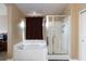 Comfortable bathroom with a tile floor, separate soaking tub, and glass shower enclosure at 6133 Alderley Ct, North Las Vegas, NV 89081