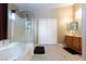 This bathroom features a glass shower enclosure, a separate soaking tub, and double closets at 6133 Alderley Ct, North Las Vegas, NV 89081
