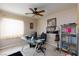 This bedroom is decorated with a glass desk, ceiling fan, and plenty of storage at 6133 Alderley Ct, North Las Vegas, NV 89081