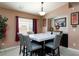 Dining room with tile flooring, light fixture, and view of backyard at 6133 Alderley Ct, North Las Vegas, NV 89081