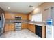 Bright kitchen with stainless steel appliances and oak cabinets at 6133 Alderley Ct, North Las Vegas, NV 89081