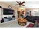 Cozy living room with carpet, fireplace, sofa, and ceiling fan at 6133 Alderley Ct, North Las Vegas, NV 89081