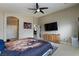 Main bedroom featuring a ceiling fan, an ensuite bath, and ample space for relaxation at 6133 Alderley Ct, North Las Vegas, NV 89081