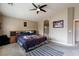 The main bedroom features a ceiling fan and an ensuite bath with an arched entry at 6133 Alderley Ct, North Las Vegas, NV 89081