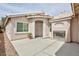 Covered patio with fireplace, tiled roof, and stucco walls at 6133 Alderley Ct, North Las Vegas, NV 89081