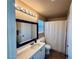 Bathroom featuring a vanity, a shower with curtain, and bright lighting for a refreshing experience at 6297 Peach Orchard Rd, Las Vegas, NV 89142