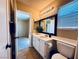 Bathroom showcasing a white vanity, ample lighting, and a modern mirror for a bright and inviting space at 6297 Peach Orchard Rd, Las Vegas, NV 89142