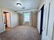 Bedroom featuring neutral walls, carpeted flooring, a window with curtains, and a closet at 6297 Peach Orchard Rd, Las Vegas, NV 89142