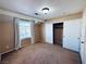 Cozy bedroom featuring neutral walls, carpeted flooring, and a window with curtains at 6297 Peach Orchard Rd, Las Vegas, NV 89142