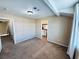 Spacious bedroom featuring carpet flooring, a view into the bathroom, and natural light at 6297 Peach Orchard Rd, Las Vegas, NV 89142