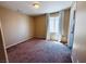 Bedroom featuring neutral walls, carpeted flooring, and a window with curtains providing natural light at 6297 Peach Orchard Rd, Las Vegas, NV 89142