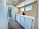 Hallway featuring built-in cabinets, carpet flooring, and two windows providing natural light at 6297 Peach Orchard Rd, Las Vegas, NV 89142