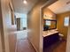 Hallway view leading to a well-lit bathroom and spacious bedroom with bright natural light at 6297 Peach Orchard Rd, Las Vegas, NV 89142