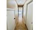 Hallway with tile flooring leading to a backyard view and featuring two doors on either side at 6297 Peach Orchard Rd, Las Vegas, NV 89142