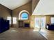 Open floor plan living room with vaulted ceiling and fireplace with backyard access at 6297 Peach Orchard Rd, Las Vegas, NV 89142