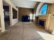 Open floor plan living room with vaulted ceiling and fireplace with backyard access at 6297 Peach Orchard Rd, Las Vegas, NV 89142