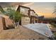 Home featuring backyard with patio area, rock landscaping, and privacy wall at 6403 Dundock Ave, Las Vegas, NV 89122