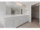 Bright bathroom features double sinks, a large mirror, and a walk-in closet at 6403 Dundock Ave, Las Vegas, NV 89122