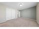 Neutral bedroom featuring carpeted floors, a ceiling light, neutral paint, and closet with double doors at 6403 Dundock Ave, Las Vegas, NV 89122
