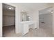 Dressing area with white vanity, large mirror, and tile flooring; access to the walk-in closet and the bedroom at 6403 Dundock Ave, Las Vegas, NV 89122