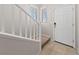 Bright entryway featuring tile flooring, a white front door, and a staircase leading upstairs at 6403 Dundock Ave, Las Vegas, NV 89122