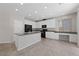 Modern kitchen featuring white cabinets, black appliances, and a granite island at 6403 Dundock Ave, Las Vegas, NV 89122