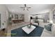 Open-concept living room features a ceiling fan, plush furniture and lots of natural light at 6403 Dundock Ave, Las Vegas, NV 89122