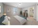 Staged main bedroom with a bed, wall art, television, and ensuite bathroom at 6403 Dundock Ave, Las Vegas, NV 89122