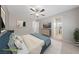 Staged primary bedroom with a bed, television, ceiling fan, and an ensuite bathroom at 6403 Dundock Ave, Las Vegas, NV 89122