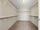 Empty walk-in closet with carpet and rods and shelves for clothing and other storage at 6403 Dundock Ave, Las Vegas, NV 89122