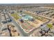 Aerial view of community with a sparkling pool, basketball court, and lush landscaping at 6952 Crimson Shadow St, North Las Vegas, NV 89086