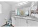 Bright bathroom with a double sink vanity, white cabinets, and tiled floors at 6952 Crimson Shadow St, North Las Vegas, NV 89086